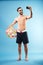 Happy shirtless guy holding beach ball and making selfie