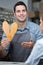 happy shoe worker holding shoes soles