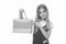 Happy shopaholic girl. Child buy modern items on sale. Girl smiling happy face pointing shopping bag, isolated white