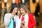 Happy shoppers checking purchases in a shooping bag