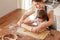 Happy siblings baking homemade cookies together at home. Children leisure activity at quarantine.