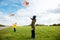 Happy siblings children running and having fun with kite on beach