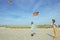 Happy siblings children running and having fun with kite on beach