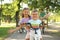 Happy siblings and their  riding bicycles in park