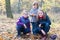 Happy siblings - Three sisters in the autumnal forest smiling