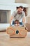 Happy single father pushing his little kid in homemade aeroplane cardboard box at home. Adorable little boy sitting in