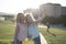 Happy sisters taking selfie after shopping in sunset image