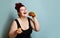 Happy size-plus overweight fat woman happy hold burger cheeseburger sandwich with beef  and french fries on pastel turquoise