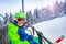 Happy ski boy sit on skier lift smile over forest