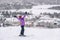 Happy skier with arms up in happiness at Mont Tremblant ski resort, Quebec, Canada. View from ski slope. Winter sports