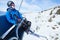 Happy skier on ski lift elevator in winter mountains