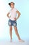 Happy slender child girl full growth in denim shorts with bare legs