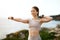 Happy slim millennial european woman in sportswear doing arm exercises with dumbbells, enjoy training