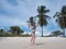 Happy slim young woman on the tropical bounty beach