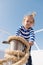 Happy small boy on yacht. Sea trip concept. funny kid in striped marine shirt. journey discovery. Transportation. summer