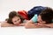 Happy smart primary school students, first grader girl and her brother, teen schoolboy, smiling over white background