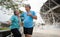 Happy and smile couples elderly asian standing on stairs for rest after workout, jogging on morning, senior exercise outdoor for