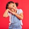 Happy, smile and cute young girl child portrait with red studio background with happiness. Smiling, youth and kid model