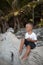 Happy smile european blond baby boy have rest and sit on white sand beach