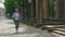 Happy smiled mature woman runner is running and holding the sport bottle on the street background. Sport and healthy