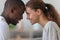 Happy smiling affectionate mixed race family couple touching foreheads.