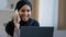 Happy smiling arabian woman muslim girl in hijab female freelancer talking by mobile phone with friend answering call
