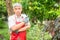 A happy and smiling Asian old elderly man is pruning twigs and flowers for a hobby after retirement in a home. Concept of a happy