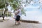 Happy and smiling asian senior retired couple, elder man and woman enjoying with retired vacation at sea beach outdoor. Health