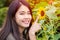 Happy smiling asian young teen with sunflower