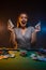 Happy smiling attractive woman win money in casino. Concept of playing poker game. Cards and chips background. Portrait of