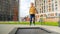 Happy smiling boy enjoys jumping and playing on playground with trampoline. Active child, sports and development, kids playing