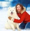 Happy smiling bright woman with Samoyed dog outdoors