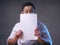 Happy Smiling Businessman Covering His Face With Blank Paper Card