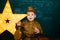 Happy smiling child boy in military uniform. Boy playing soldier