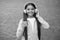 happy smiling child enjoys listens to music in headphones. kid listen song outdoor. walking with favorite tune