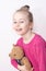 Happy smiling child girl in pyjamas with teddy bear - bedtime