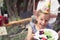 Happy smiling child girl treating healthy eating with plate of vegetables during back yard birthday party