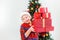 Happy smiling child holding pile of present boxes