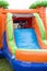 Happy smiling children playing on an inflatable slide bounce house