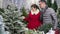 Happy smiling couple doing Christmas shopping in market store