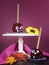 Happy smiling crazy face red toffee apples candy on stand for trick or treat Halloween