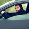 Happy smiling driver man behind the wheel of his car