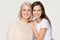 Happy smiling elder mother and millennial daughter posing for portrait