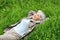 Happy smiling elderly woman lying on green grass meadow in spring