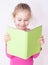 Happy smiling five years old child girl reading a book