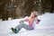 Happy smiling girl with lifted hands on snowboard