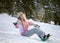 Happy smiling girl with lifted hands on snowboard