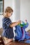 Happy smiling girl preparing for school her backpack. First day of school. Back to school concept. Little child