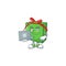 Happy smiling green gift box cartoon character working with laptop