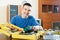 Happy smiling guy organizes tools on table